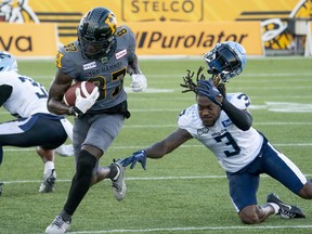 Toronto Argonauts defensive back Jamal Peters (3) loses his helmet while attempting to tackle Hamilton Tiger-Cats wide receiver Richie Sindani (87) during CFL action in Hamilton, Ont., Monday, Sept. 4, 2023. Peters is getting a head start on getting acclimated to his new football home. The six-foot-two, 220-pound cornerback is in town this week participating in the CFL's off-season marketing initiative.