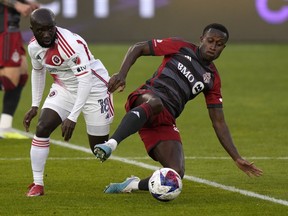 Toronto FC midfielder Richie Laryea (22) vies for the ball with New England Revolution midfielder Ema Boateng (18) during MLS soccer action in Toronto on Saturday May 6, 2023. Toronto FC is in discussions to bring in a player and to move one out in advance of Tuesday's closing of the MLS's primary transfer window.THE CANADIAN PRESS/Frank Gunn
