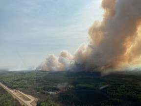 An out-of-control wildfire in northeastern British Columbia has triggered the province's first evacuation of this year's fire season. A wildfire burns in the Peace River Regional District of British Columbia in a May 5, 2023, handout photo.