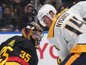 Vancouver Canucks goalie Thatcher Demko, left, and Nashville Predators' Gustav Nyquist watch the puck during NHL action in Vancouver, on Tuesday, October 31, 2023. On Sunday, the Canucks will host their first home playoff game since 2015 when they kick off a first-round matchup against the Predators.
