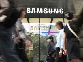 People pass by a Samsung Gangnam store in Seoul, South Korea, Tuesday, April 30, 2024. Samsung Electronics on Tuesday reported a 10-fold increase in operating profit for the last quarter as the expansion of artificial intelligence technologies drives a rebound in the markets for computer memory chips.