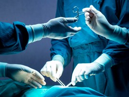 Doctors operating in a surgery room.