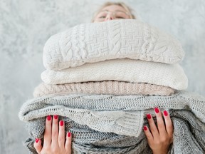 woman stacking sweaters