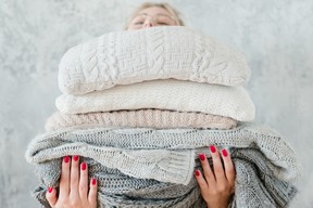 woman stacking sweaters