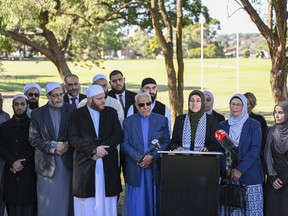 Ramia Abdo Sultan, lawyer and communications relations advisor of the Australian National Imams Council with Imams speaks during a press conference, in Sydney, Friday, April 26, 2024. Muslim groups in Australia on Friday criticized the disparity in the police response to two stabbing attacks in Sydney this month, saying it had created a perception of a double standard and further alienated the country's minority Muslim community.