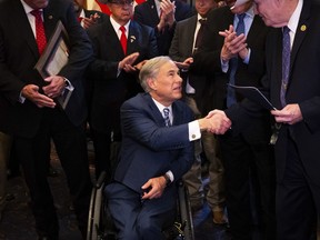Texas Gov. Greg Abbott greets sheriffs from counties across Texas during a meeting between the governor and the sheriffs at the Texas State Capitol in Austin, Wednesday, March 20, 2024.