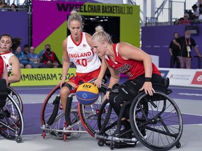 Canada's Kady Dandeneau heads past England's Amy Conroy on the way to a 13-8 victory in women's 3x3 wheelchair basketball action at the Commonwealth Games in Birmingham, England on Sunday, July 31, 2022.