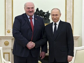 Russian President Vladimir Putin, right, and Belarus President Alexander Lukashenko pose for a photo during their meeting at the Kremlin in Moscow, Russia, Thursday, April 11, 2024.