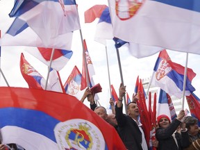 Supporters of Bosnian Serb political leader Milorad Dodik wave Serbian flags during protest against what he claims is Western aggression against Republika Srpska entity in the Bosnian town of Banja Luka, 240 kms northwest of Sarajevo, Thursday, April 18, 2024.