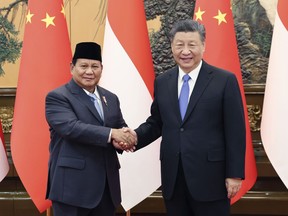 In this photo released by Xinhua News Agency, Chinese President Xi Jinping at right shakes hands with Indonesian President-elect Prabowo Subianto at the Great Hall of the People in Beijing on Monday, April 1, 2024.