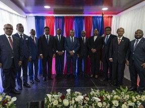 Interim Prime Minister Michel Patrick Boisvert, fifth from left, poses for a group photo with members of a transitional council tasked with selecting a new prime minister and cabinet, in Port-au-Prince, Haiti, Thursday, April 25, 2024.
