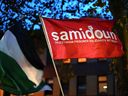 A photo shows a flag of the organization 'Samidoun' during a
