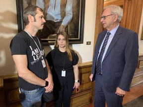 Fredericton parents Eli and Michal Tsurkan speak with Premier Blaine Higgs at the New Brunswick legislature Friday. They say their daughter, Shaked, was beaten up in a parking lot due to her ethnicity.