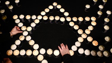 Women light candles in the shape of the Star of David during the symposium on fighting antisemitism on January 22, 2024 in Krakow, Poland.