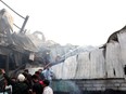 Firefighters try to extinguish a fire which broke out at an amusement park facility in Rajkot, in India's Gujarat state on Sunday, May 25, 2024. At least 20 people were killed, most of them children.
