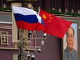 Russian and Chinese flags fly in Beijing.