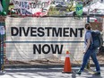 A "Divestment now" sign is seen on a fence enclosing the anti-Israel encampment at the University of Toronto on May 7, 2024.