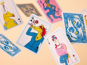 A number of illustrated playing cards falling from the air.