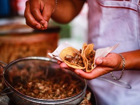 Heriberto prepares tacos at the El Jarocho stand at Insurgentes Avenue on April 17, 2020, in Mexico City, Mexico.