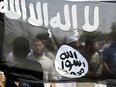 Jordanian protesters hold an Al-Qaida-affiliated flag during a demonstration against an amateur film mocking Islam near the U.S. embassy in Amman on Sept. 14, 2012.