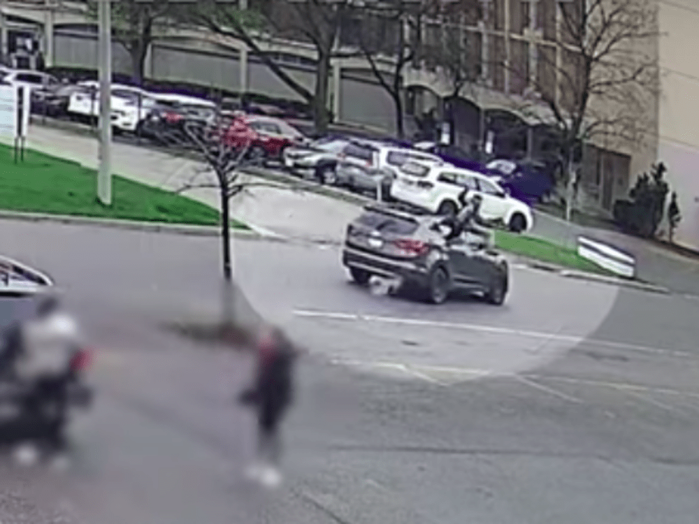 Video shows suspected car thief driving stolen vehicle into police
officer