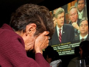 A residential school survivor weeps.