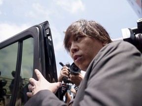Ippei Mizuhara, the former longtime interpreter for the Los Angeles Dodgers baseball star Shohei Ohtani, gets into a vehicle following his arraignment at federal court, Tuesday, May 14, 2024 in Los Angeles. Mizuhara pleaded not guilty Tuesday to bank and tax fraud, a formality ahead of a plea deal he's negotiated with federal prosecutors in a wide-ranging sports betting case.