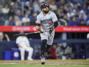 Minnesota Twins' Carlos Santana (30) watches the ball fly as he hits a solo home run against the Toronto Blue Jays during fifth inning MLB baseball action in Toronto on Friday, May 10, 2024.