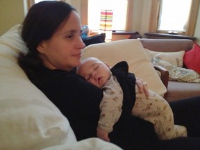 Wendy Porch, who was born missing part of her right arm and part of her left hand, is pictured with her son Jasper when he was four months old in this handout image. Porch was on the advisory committee for a new report that says one in eight people who are pregnant in Ontario has a disability, but many face barriers to accessible care.