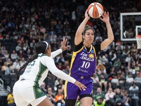 Los Angeles Sparks' Kia Nurse (10) makes the pass as Seattle Storm's Victoria Vivians (35) tries to block during second half WNBA preseason action in Edmonton on Saturday, May 4, 2024.THE CANADIAN PRESS/Jason Franson
