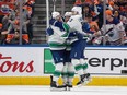 Vancouver Canucks' J.T. Miller (9), Brock Boeser (6) and Elias Lindholm (23) celebrate a goal during second period second-round NHL playoff action against the Edmonton Oilers, in Edmonton, Sunday, May 12, 2024.