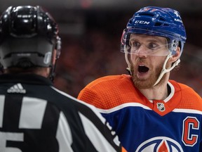 Edmonton Oilers' Connor McDavid (97) argues with the referee during second period of second-round NHL playoff action against the Vancouver Canucks, in Edmonton, Sunday, May 12, 2024.