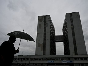 A man walks with an umbrella past the F. D. Roosevelt University Hospital, where Slovak Prime Minister Robert Fico, who was shot and injured on May 15, is being treated, in Banska Bystrica, central Slovakia, Friday, May 17, 2024. Fico, 59, was shot multiple times on Wednesday as he was greeting supporters after a government meeting in the former coal mining town of Handlova. Officials at first reported that doctors were fighting for his life but after a five-hour operation described his situation as serious but stable.