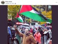 Haythem Abid holds a large Palestinian flag