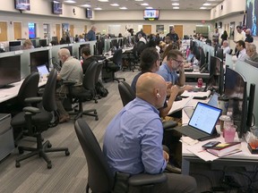 In this image taken from video, Florida Power Light employees work inside the company's command center during a hurricane storm drill in West Palm Beach, Fla., Thursday, May 9, 2024. The company is preparing for this year's hurricane season by pretending a major storm already hit.