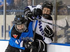 Toronto's Brittany Howard (41) drives Minnesota's Maggie Flaherty (19) into the boards during second period PWHL action in Toronto on Wednesday May 1, 2024.