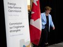 Commissioner Justice Marie-Josee Hogue makes her way on stage to deliver remarks on the interim report following its release at the Public Inquiry Into Foreign Interference in Federal Electoral Processes and Democratic Institutions, in Ottawa, Friday, May 3, 2024.