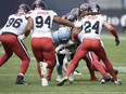 He missed time last season with a concussion but Toronto Argonauts receiver Tom Nield won't be wearing a Guardian cap in CFL games. Nield (81) is swarmed by Montreal Alouettes defensive lineman Mustafa Johnson (94) and defensive back Marc-Antoine Dequoy (24), among others, during first half CFL football action in Toronto, Saturday, Sept. 9, 2023.