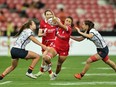 Canada's Shalaya Valenzuela, centre with ball, attacks the Spain defence on Day 1 of the HSBC SVNS at National Stadium in Singapore in a Friday, May 3, 2024, handout photo.