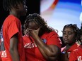 Chantemekki Fortson, the mother of slain airman Roger Fortson, center, weeps during a news conference describing details of the airman's death, Thursday, May 16, 2024, in Stonecrest, Ga.