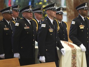 Pallbearers bring in the casket of Chicago police officer Luis M. Huesca for his funeral at St. Rita of Cascia Shrine Chapel in Chicago, Monday, April 29, 2024. Huesca was shot to death while off-duty and heading home from work.