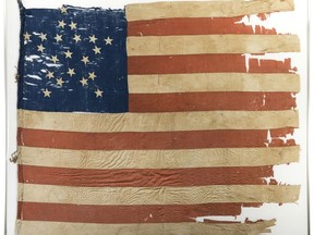 This image provided by Heritage Auctions, shows 21-star U.S. flag. Illinois state investigators are scrutinizing the purchase by the Abraham Lincoln Presidential Library and Museum of this 21-star U.S. flag reportedly from 1818-1819 at the time that Illinois was admitted to the Union as the 21st state. At the same time, one of the nation's top vexillologists, or flag experts, says the flag is not from 1818 but from the Civil War period and is likely a so-called Southern exclusionary flag, reserving on its blue canton space for stars representing only those states remaining loyal to the Union. (Heritage Auctions via AP)