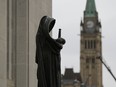 Sculpture of Lady Justice is seen on the steps of the Supreme Court of Canada.