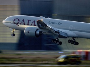 A Qatar airways plane lands at the airport in Frankfurt, Germany, as the sun rises on Sept. 25, 2023.