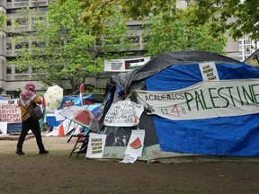 A person walks past the pro-Palestinian encampment on McGill University campus, in Montreal on May 13, 2024.