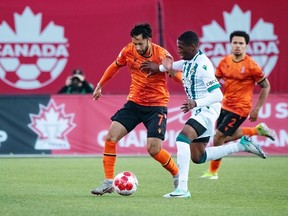 Forge FC midfielder David Choiniere, left, fends off a York United FC defender in Canadian Championship preliminary-round play in Hamilton in this Wednesday, May 1, 2024 handout photo.