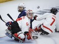 Team USA forward Travis Dodson (9) has his shot deflected by Team Canada goalie Adam Kingsmill (54) during second period action in the World Para Ice Hockey Championship final in Calgary, Sunday, May 12, 2024.