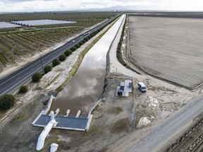 FILE - In this aerial drone photo provided by the California Department of Water Resources, the primary pump in the foreground is part of a groundwater recharge project designed to capture excess flow for groundwater storage in Fresno County on March 13, 2023. After massive downpours flooded California's rivers and packed mountains with snow, the state reported Monday, May 6, 2024, the first increase in groundwater supplies in four years.