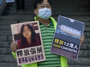 FILE - A pro-democracy activist holds placards with the picture of Chinese citizen journalist Zhang Zhan outside the Chinese central government's liaison office, in Hong Kong, Monday, Dec. 28, 2020. The whereabouts of Zhan, who served four years in prison for reporting on the early days of the pandemic in Wuhan and was expected to be released Monday, May 13, 2024, are unknown, raising concern from activists. Zhan, who had been sentenced to four years in prison on charges of "picking quarrels and provoking trouble," a vaguely defined charge often used in political cases, has finished serving her sentence at Shanghai's Women Prison.