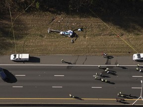 FILE - In this image taken with a drone, emergency personnel work at the scene of a helicopter crash on the side of Interstate 77 South in Charlotte, N.C., Nov. 22, 2022. Investigators found disconnected and missing hardware aboard the helicopter that crashed in 2022, killing the pilot and a North Carolina television station's meteorologist, according to the National Transportation Safety Board's final report on the crash, which was released Thursday, May 2, 2024.
